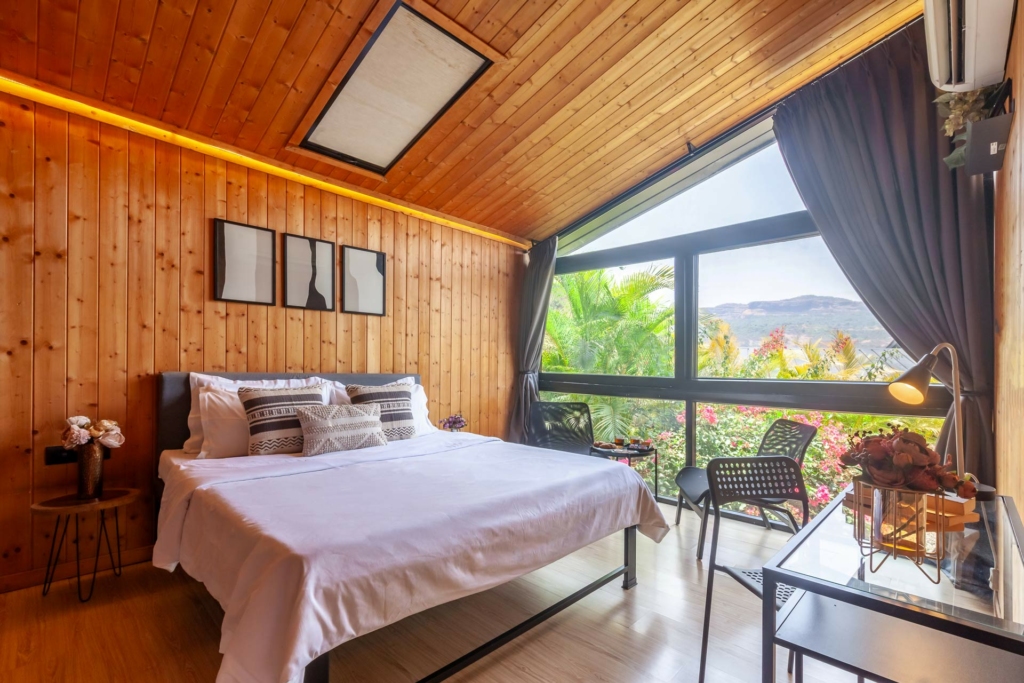 bedroom of wooden cabin near Mumbai with amazing valley view