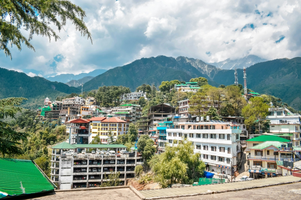 One of the best places to visit in Dharamshala in McLeodGanj
PC: Aditya Chache - https://unsplash.com/photos/a-city-with-mountains-in-the-background-nGp7qL9N8bY