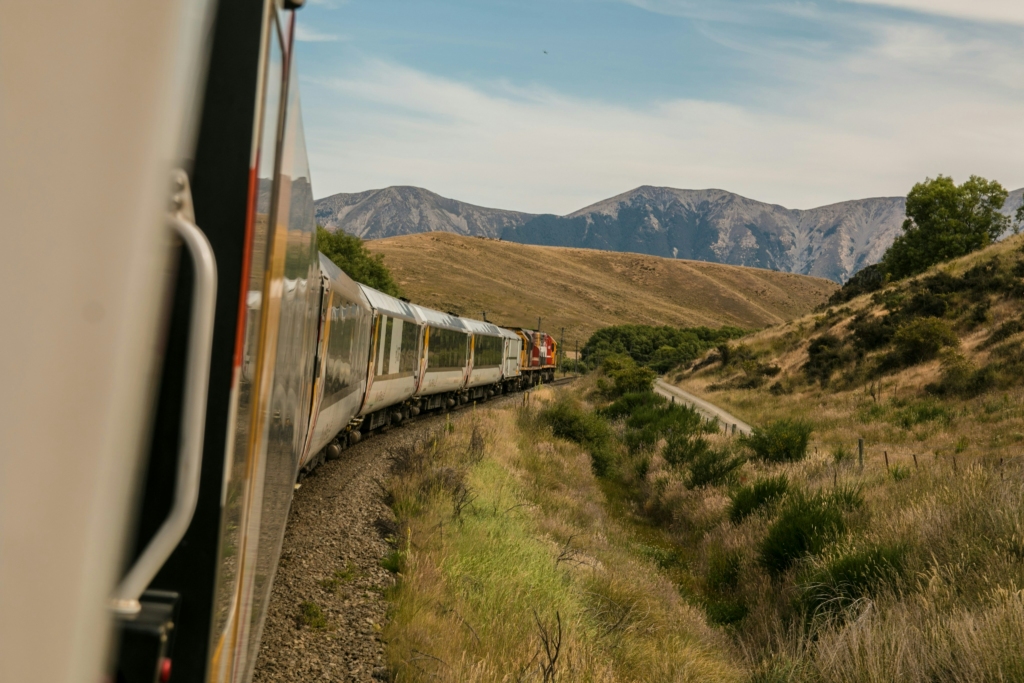 How to reach Dharamshala by train
PC: Josh Nezon - https://unsplash.com/photos/white-train-with-the-distance-of-mountain-during-daytime-R1Zb58LmwIY